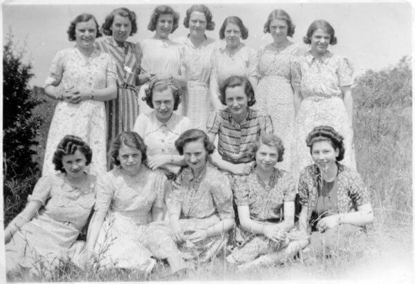 Fourteen young women posing in a field. They probably worked for Phipps, c.1940 © High Wycombe Museum 
